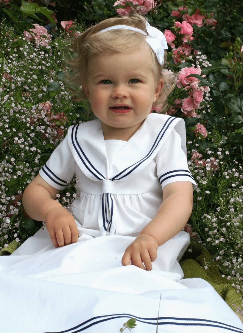 Christening gown in white and navy blue sailor look. Grace of Sweden