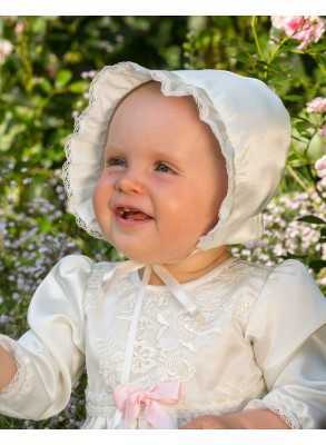 Christening bonnet on happy girl